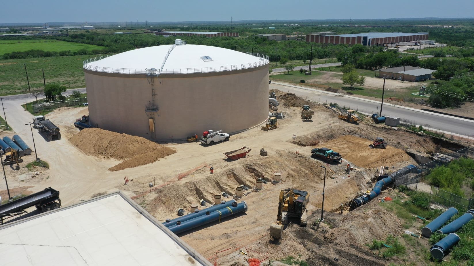 An aerial view of a construction site with a large tank.