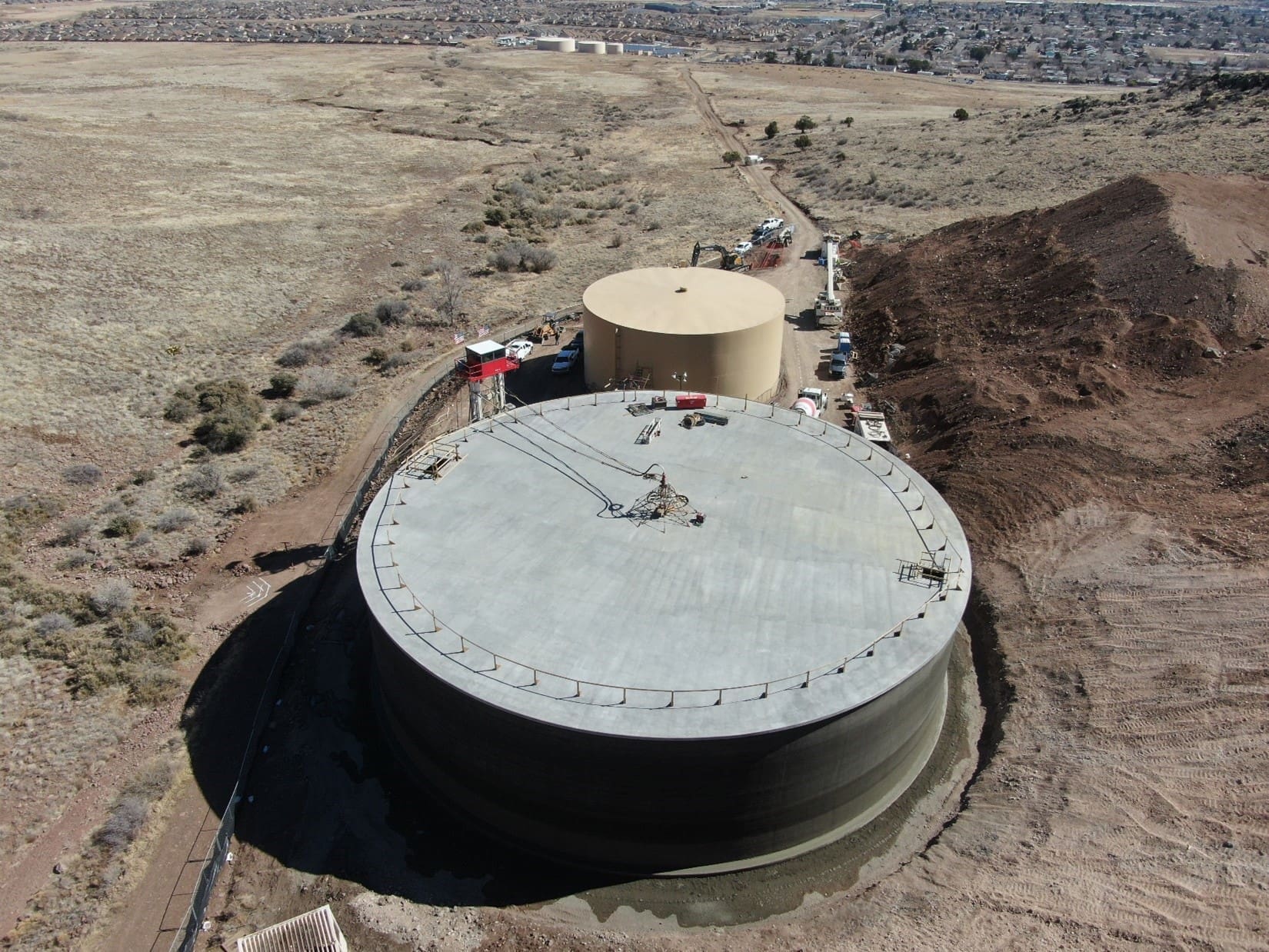 An aerial view of a large water tank in the desert.